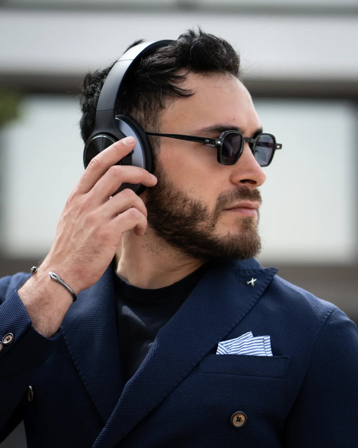 Original Oneodio listing photograph of a listener reaching for the earcup controls